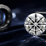 Close-up of a precision-cut round brilliant diamond with hearts-and-arrows optical symmetry, displayed beside a jeweler’s loupe on a dark luxury background.